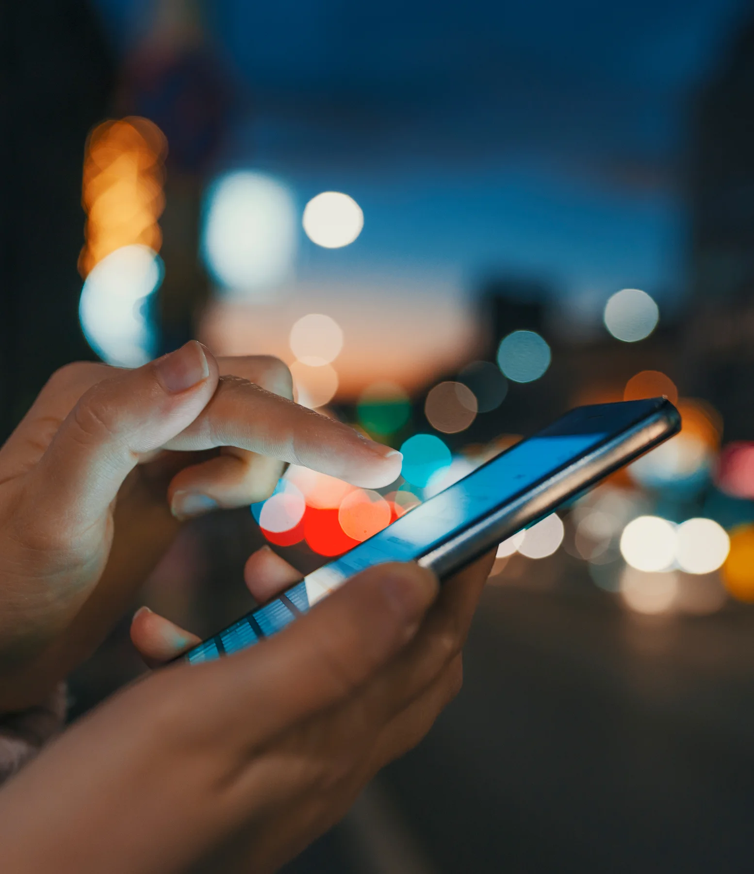 a person using a phone at night